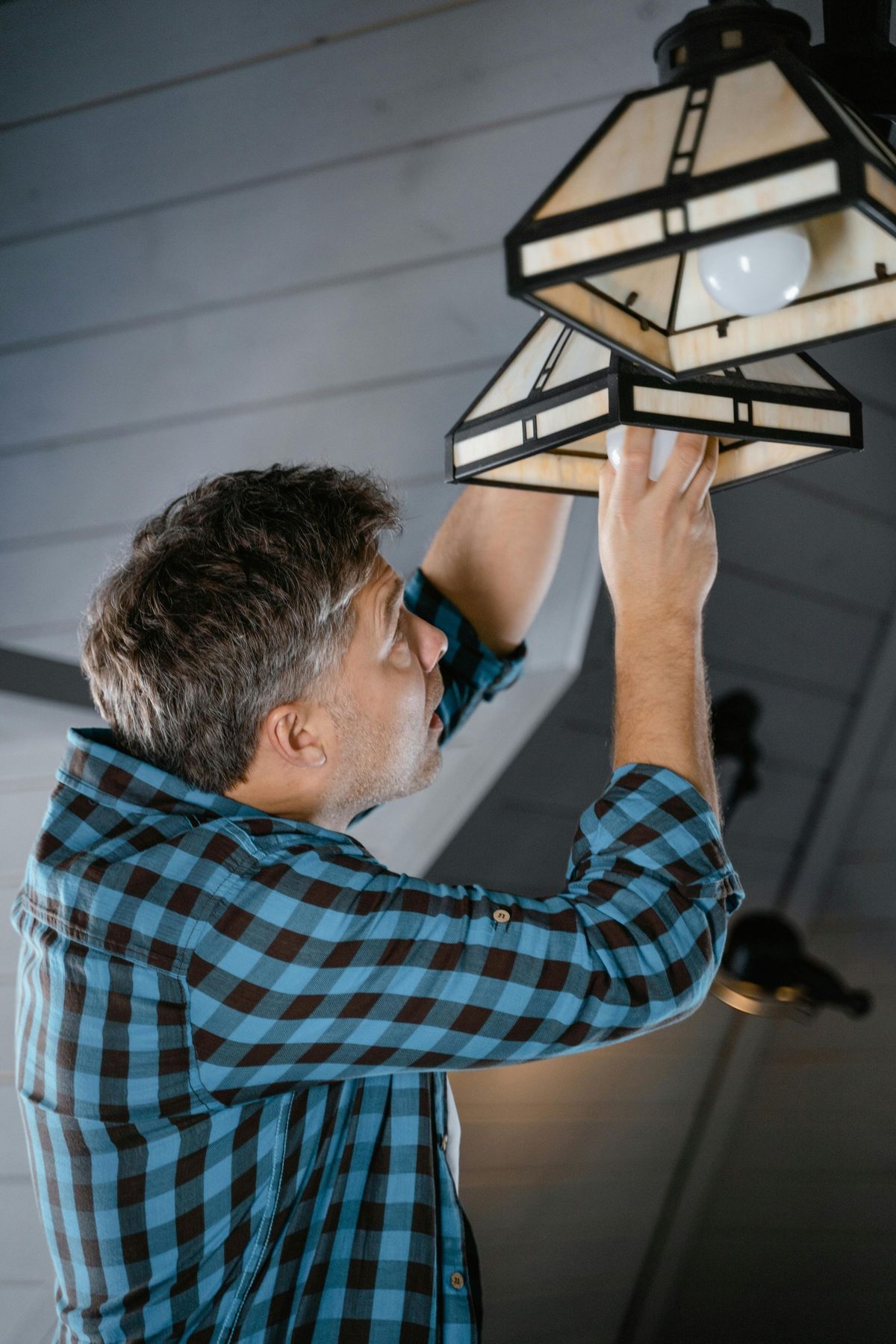 Electrician testing a light fixture.