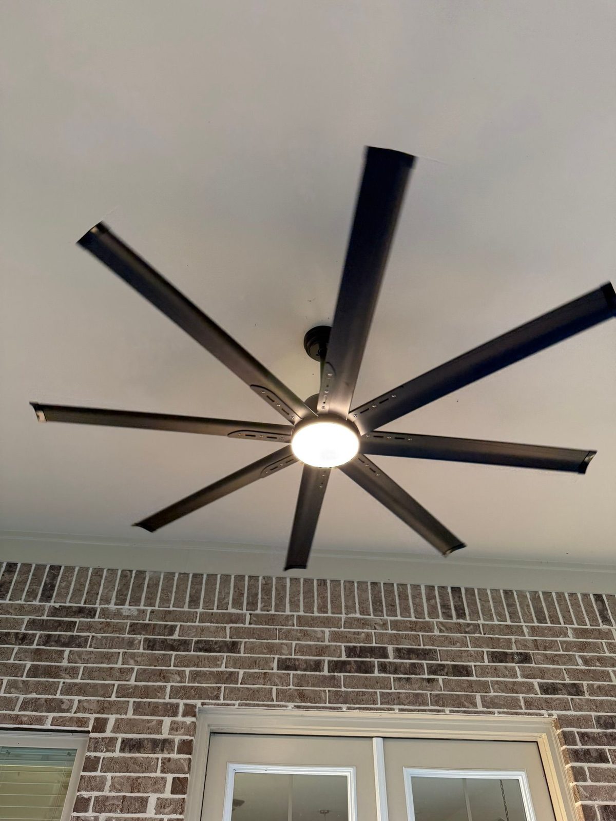Ceiling fan with light fixture installed in a living room.